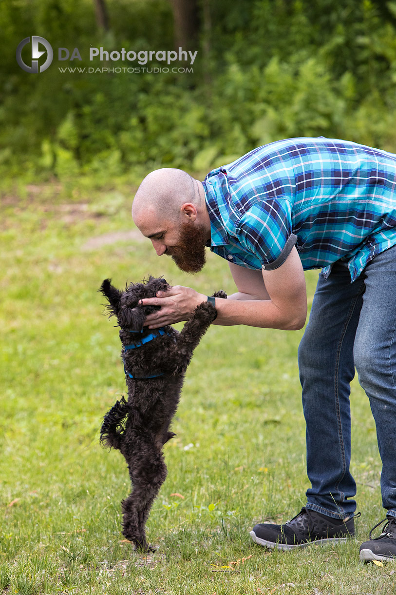 Photo of a man playing with his puppy