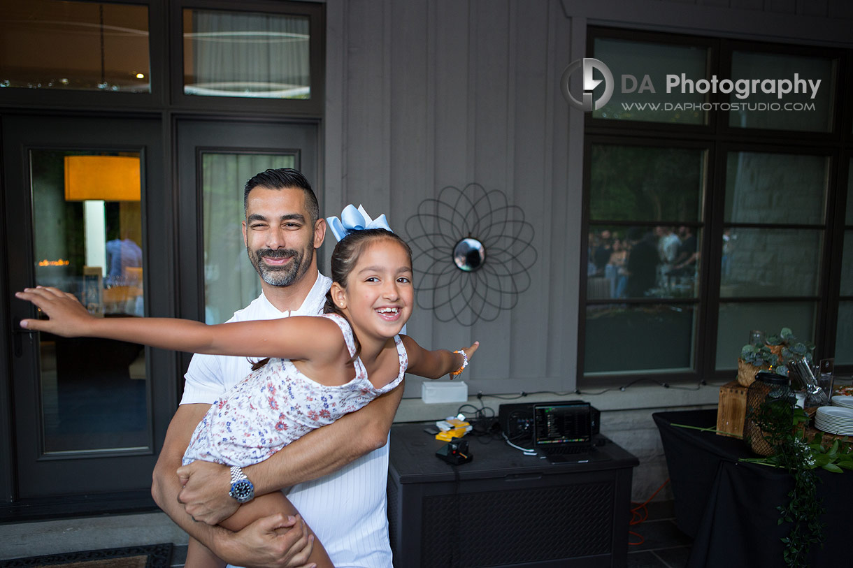 Photo of Dad with his daughter during backyard party