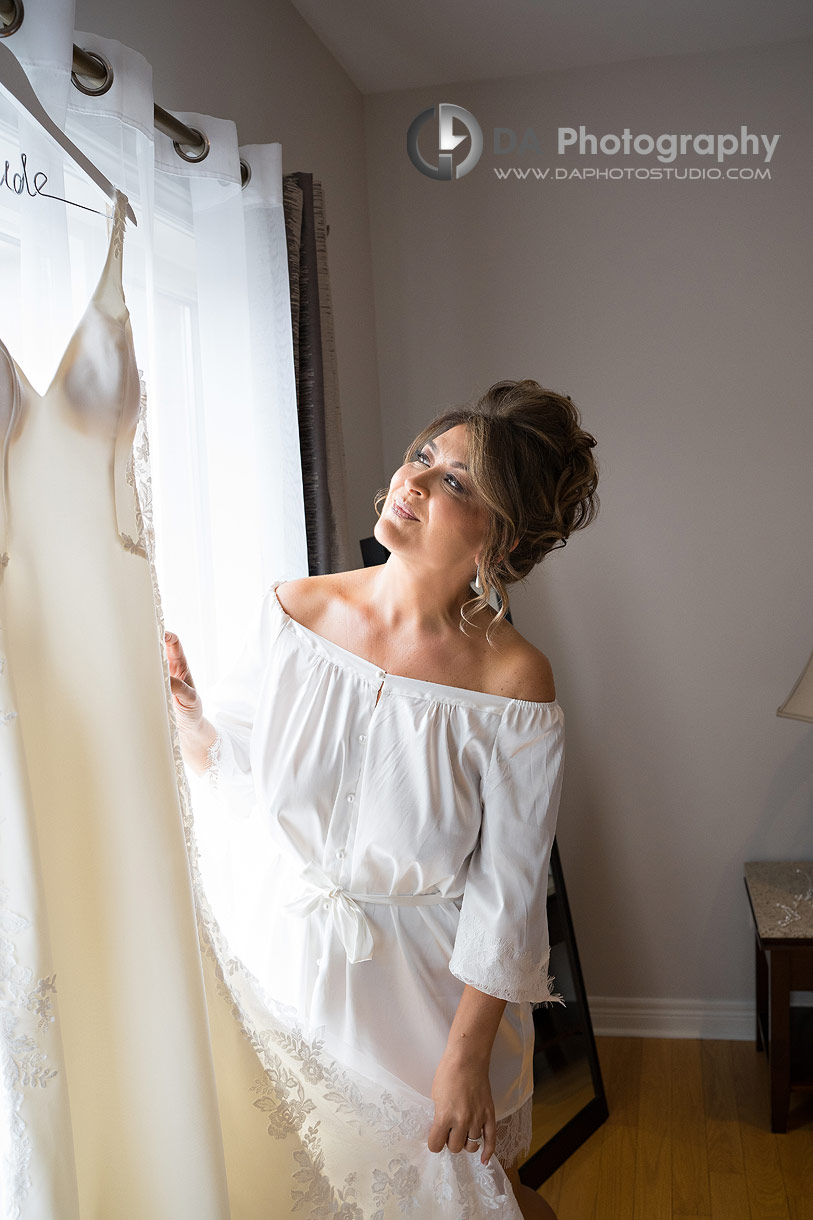Bride adjusting her wedding dress