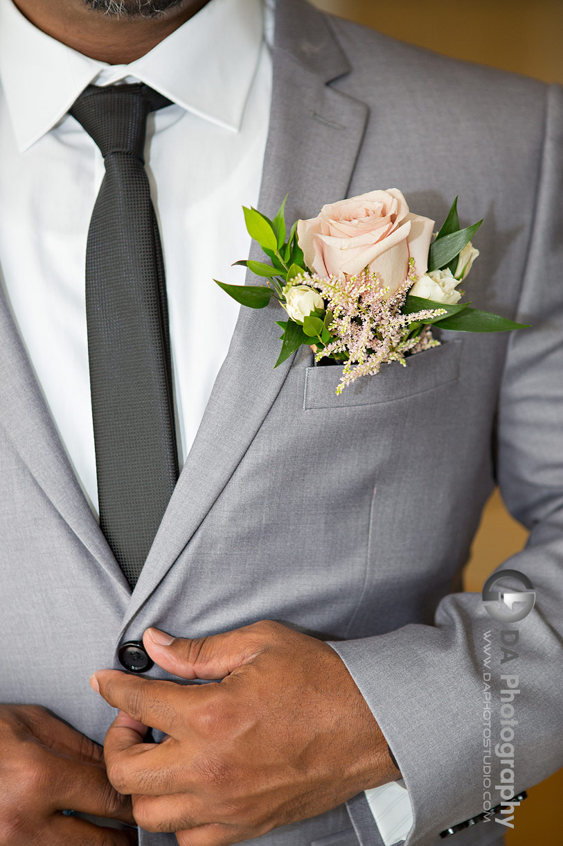 Close up photo of a groom's flower boutonniere