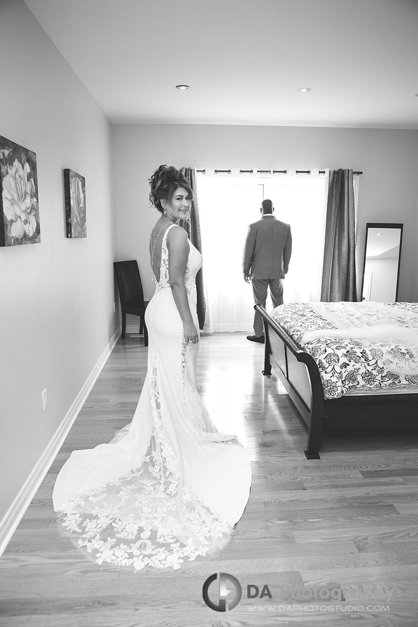 Bride is approaching her husband-to-be for a first look photo