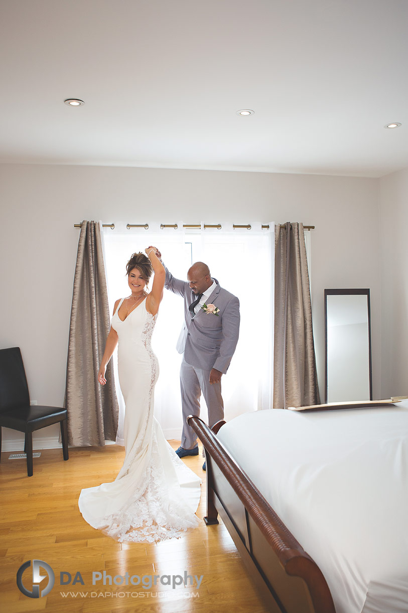 Photo of a groom twirling his wife-to-be after a first-look photos