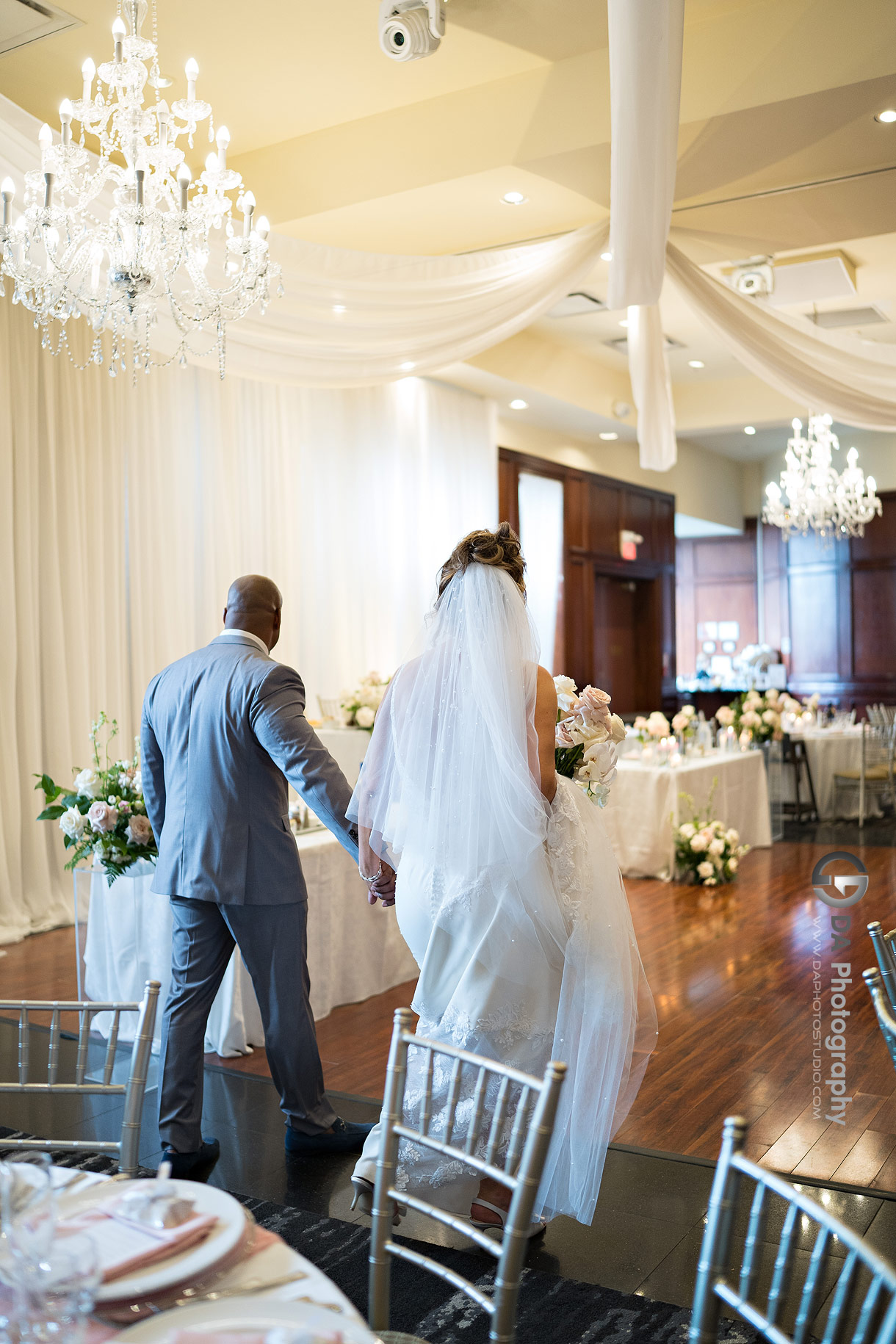 Photo of bride and groom while revealing their wedding room setup