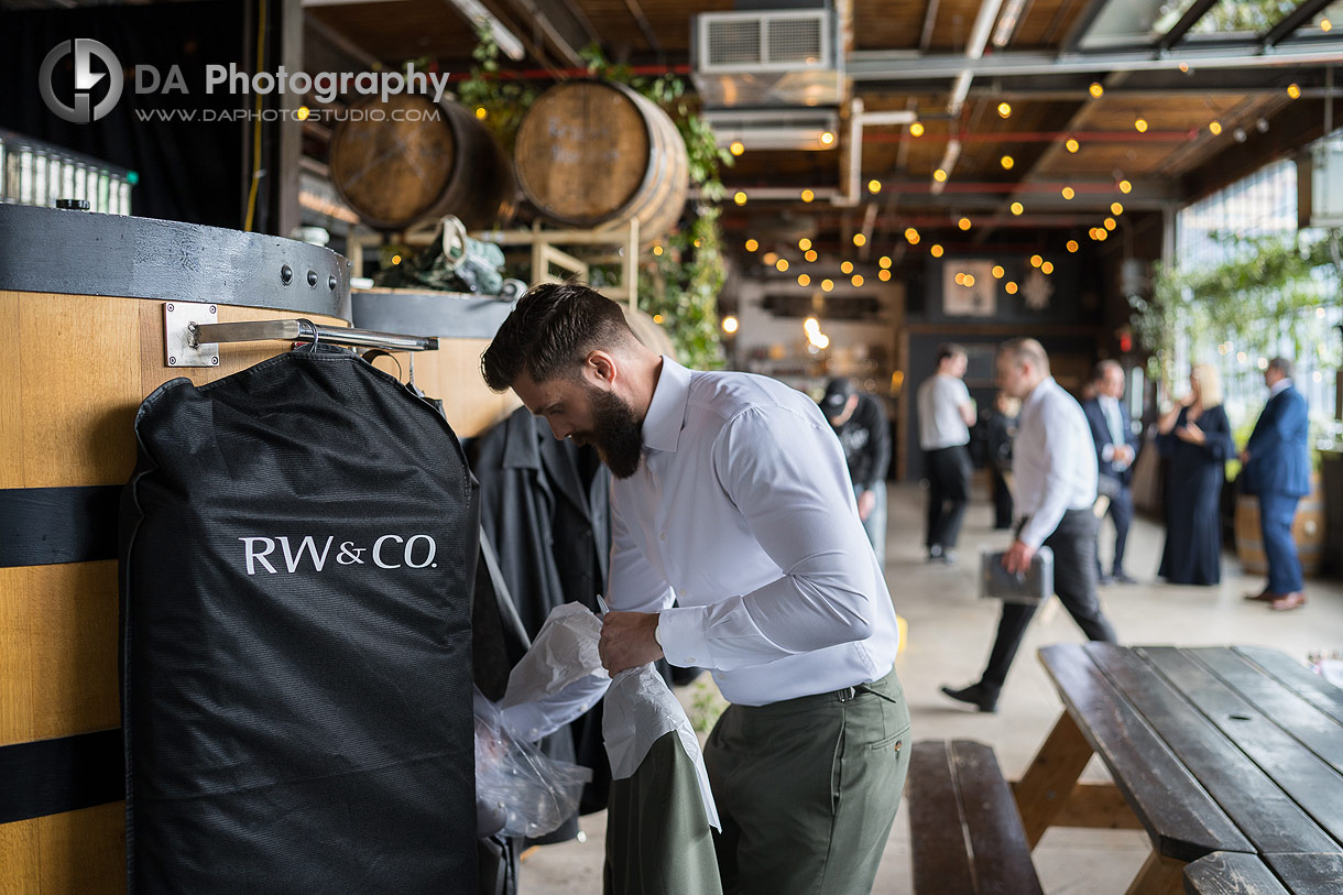 Groom getting ready at Rainhard Brewing Co