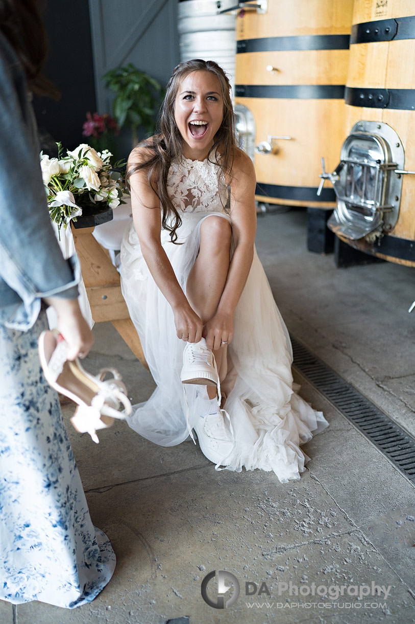 Photo of a bride getting her dancing shoes on