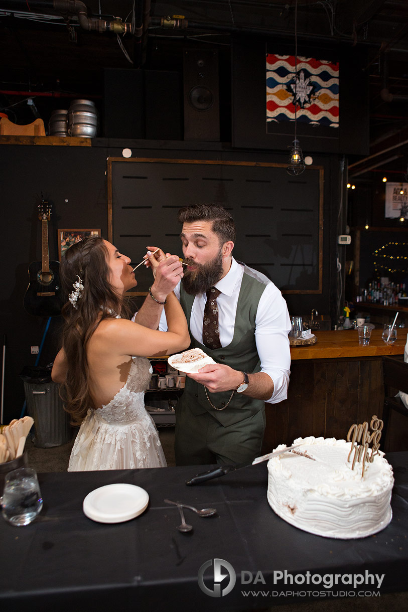 Photo of a bride and groom cutting their wedding cake