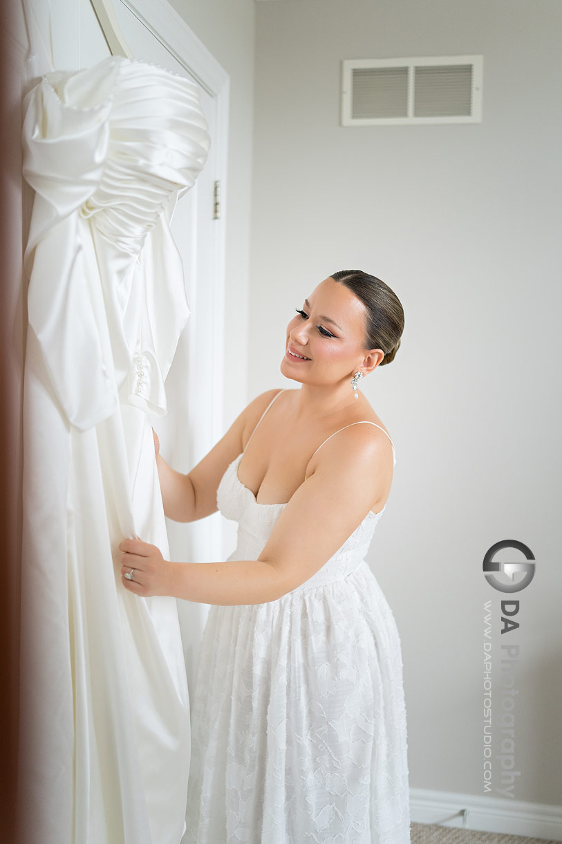 Photo of a bride touching her dress in Guelph