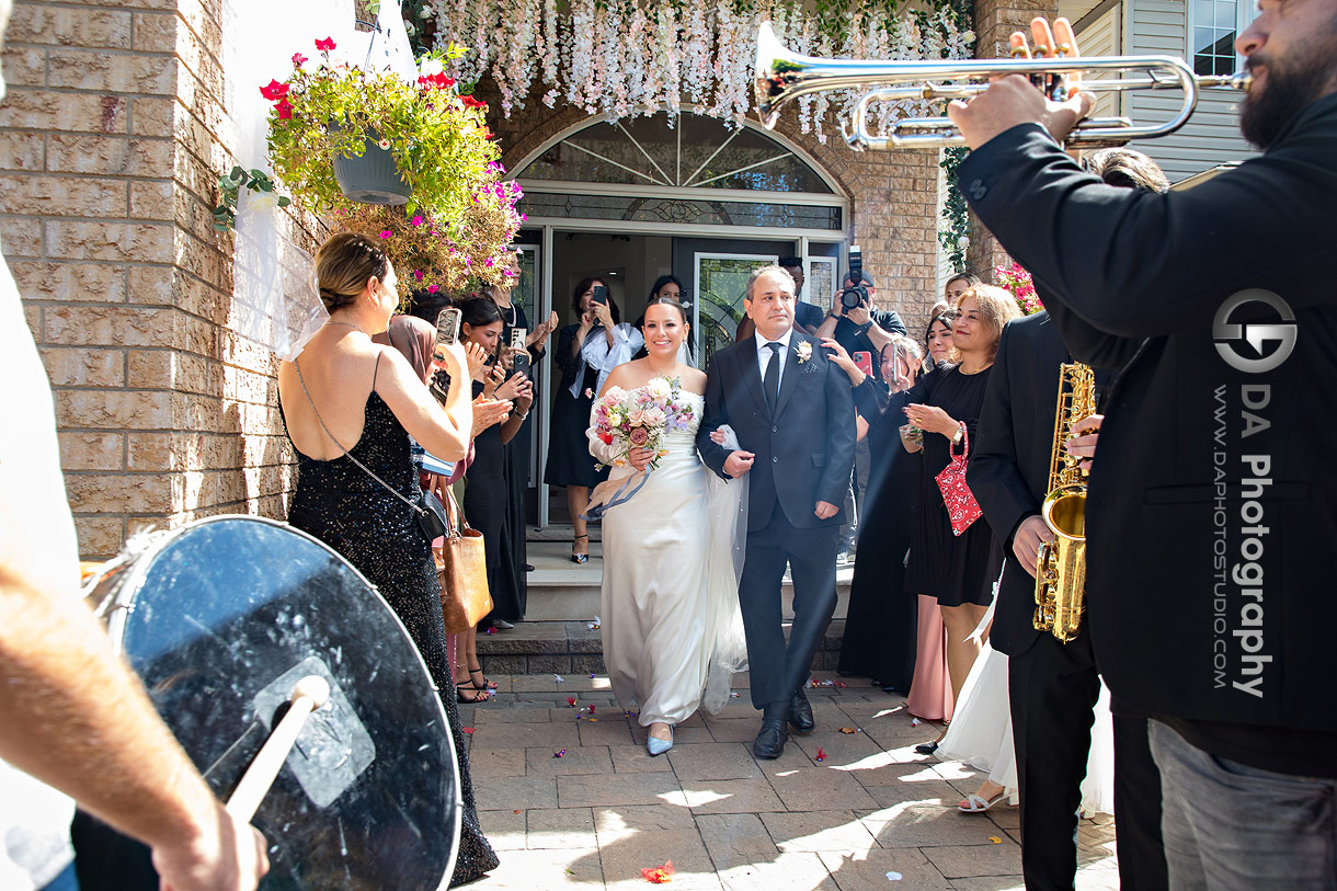 Photo of a dad walking out her daughter during Turkish home wedding ceremony