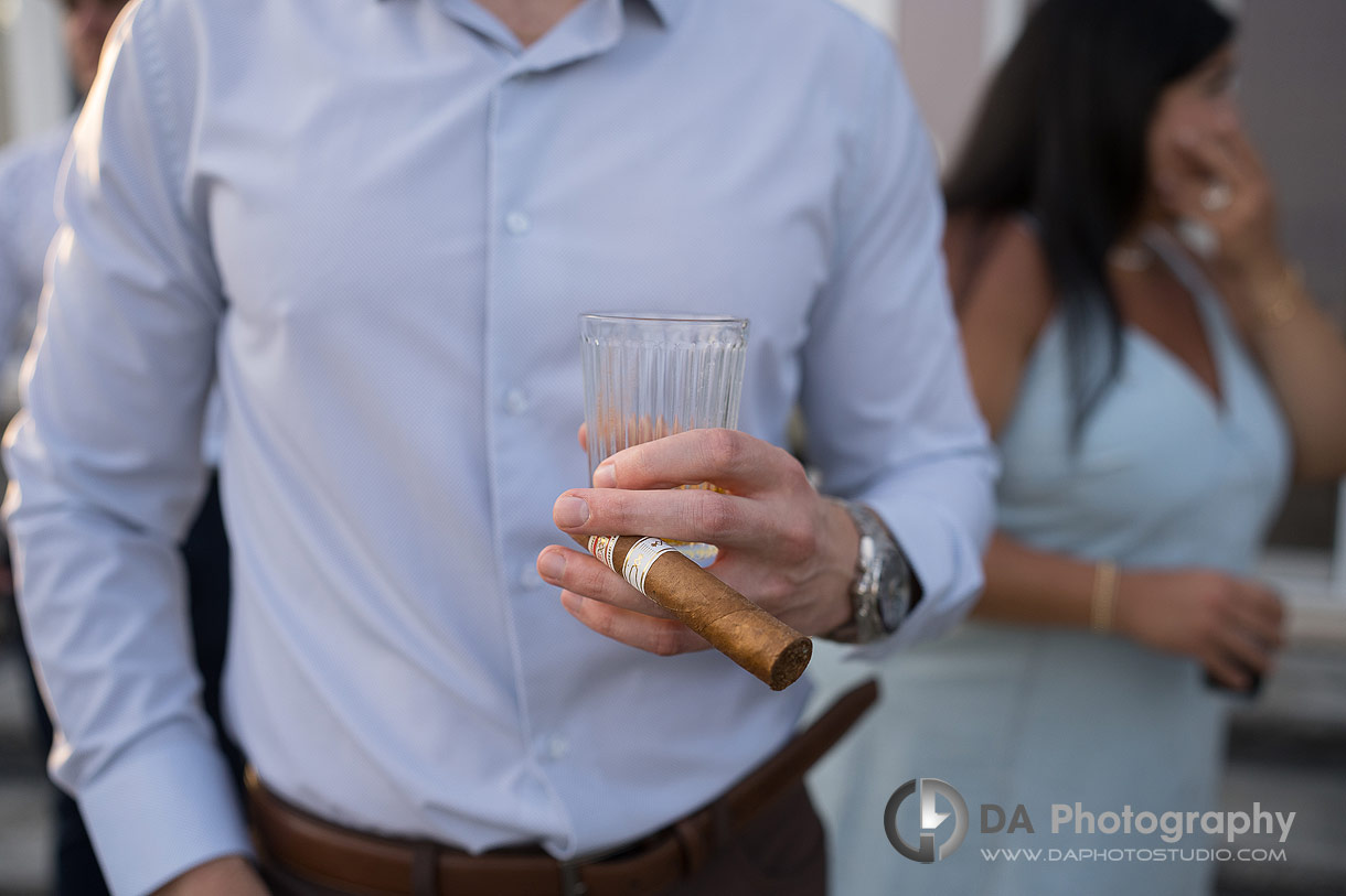 Close up photo of a man holding a cigar in celebration of marriage proposal 