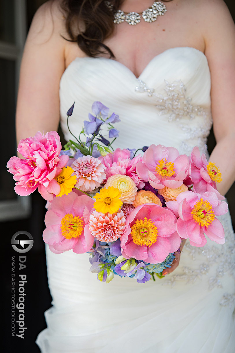 Photo of a bride holding her colourful flowers Photo of a bride holding her colourful flowers
