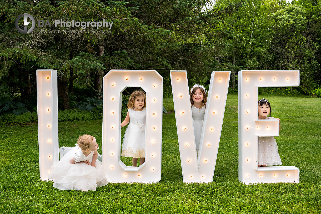 Photo of a flower girls by LOVE letters display Photo of a flower girls by LOVE letters display