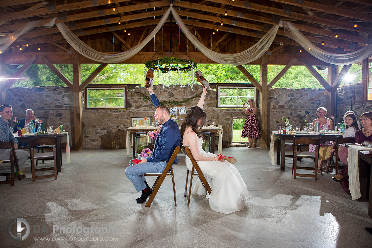 Photo of a bridge and groom playing the shoe game Photo of a bridge and groom playing the shoe game