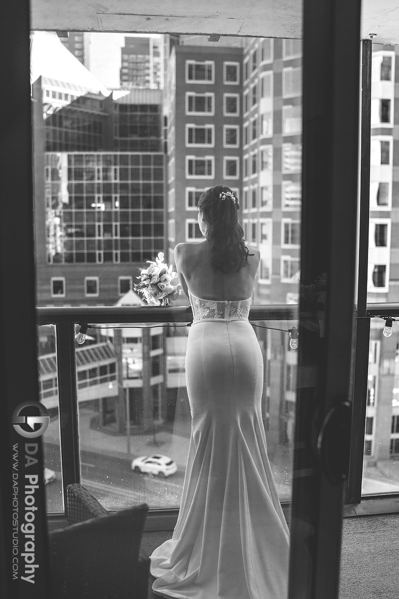 Photo of a bride on a balcony waiting for her groom to pick her up Photo of a bride on a balcony waiting for her groom to pick her up