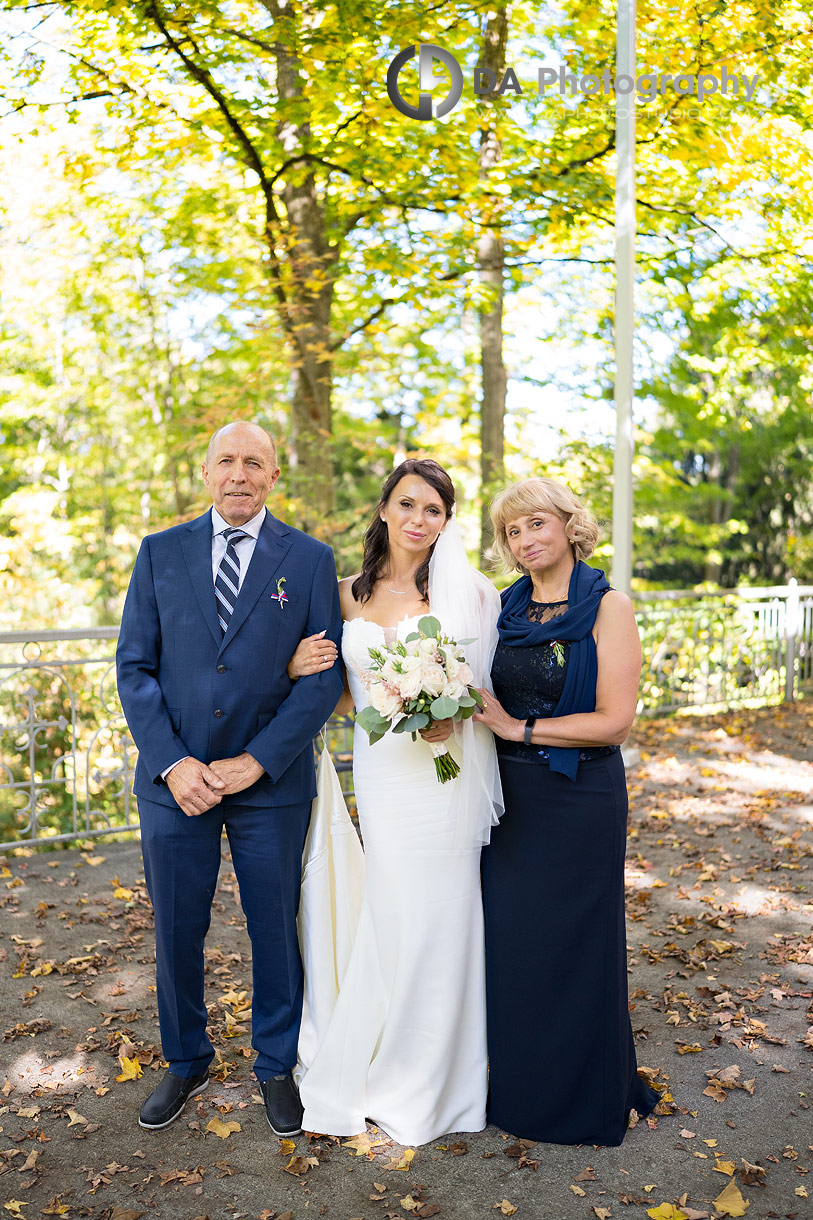 Photo of a bride with her parents right before their church wedding ceremony Photo of a bride with her parents right before their church wedding ceremony