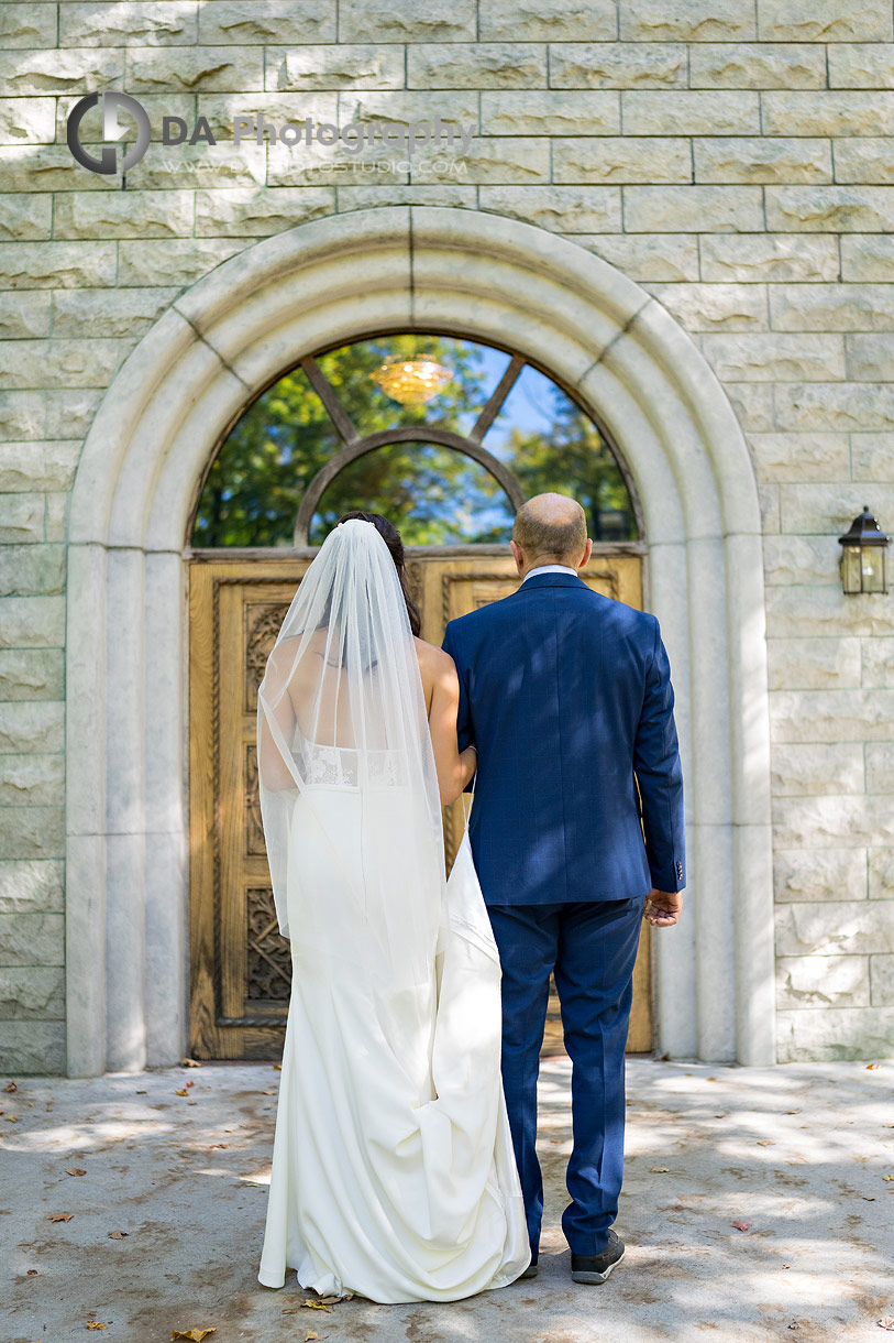 Photo of a bride with her dad in front of the church right before their wedding ceremony Photo of a bride with her dad in front of the church right before their wedding ceremony
