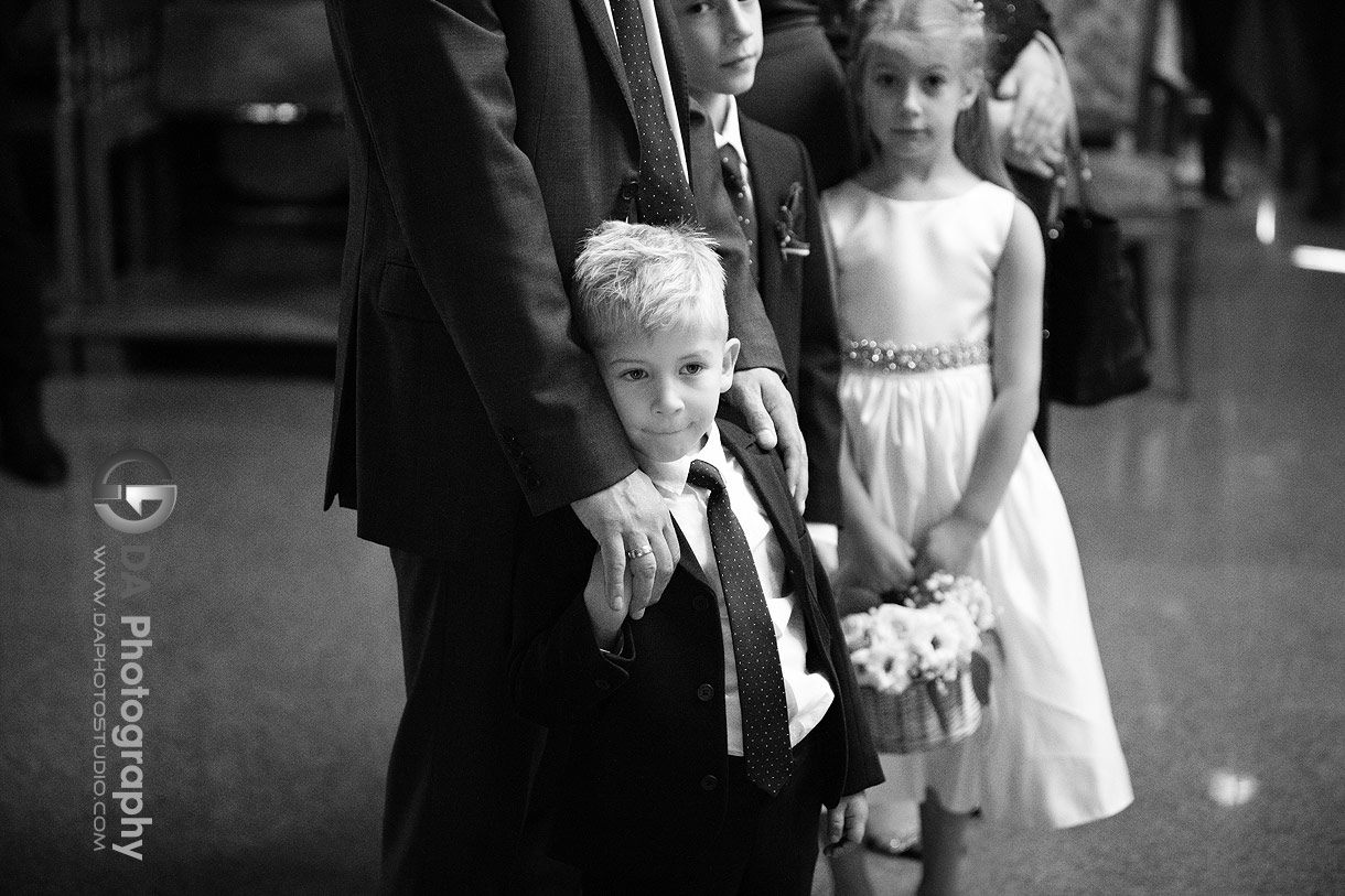 Photo of a ring bearer watching a traditional church wedding ceremony Photo of a ring bearer watching a traditional church wedding ceremony