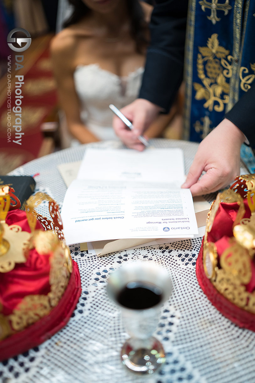 Photo of a signing a marriage certificate on a church wedding ceremony Photo of a signing a marriage certificate on a church wedding ceremony