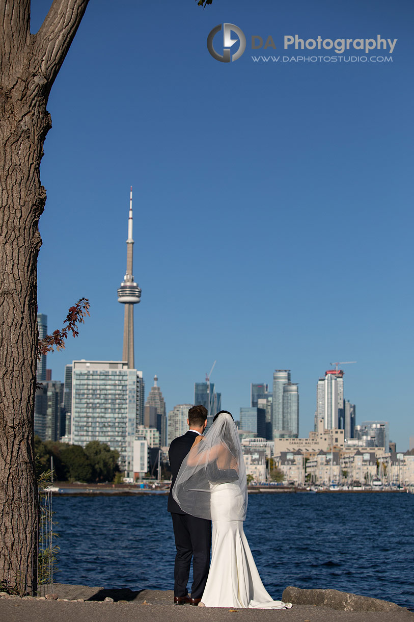 Wedding couple by Lake Ontario facing CN Tower Wedding couple by Lake Ontario facing CN Tower