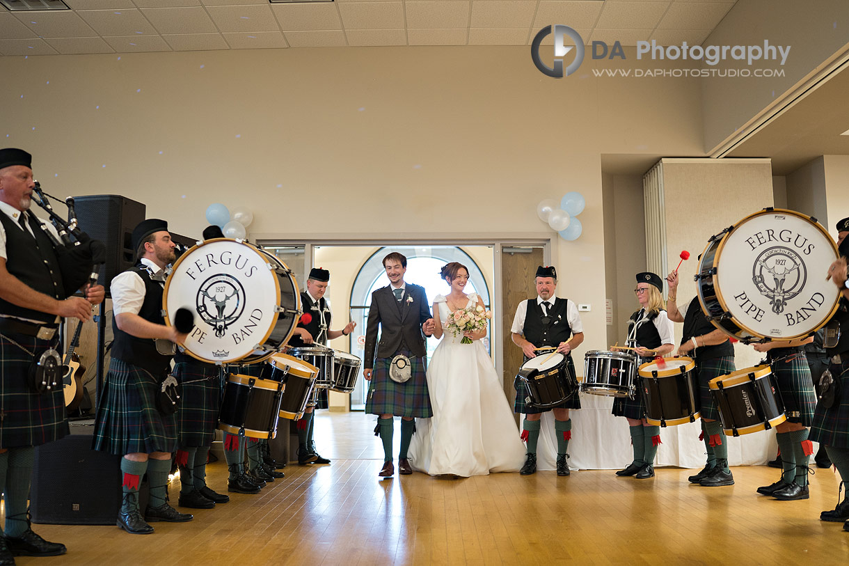 Bride and Groom entering an wedding reception with a music of a pipe band