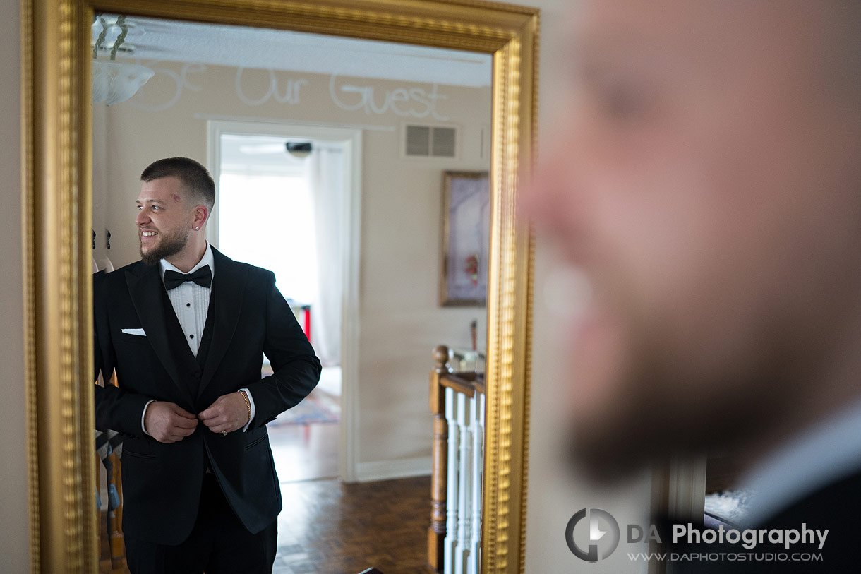 Photo of a groom reflection in the mirror Photo of a groom reflection in the mirror