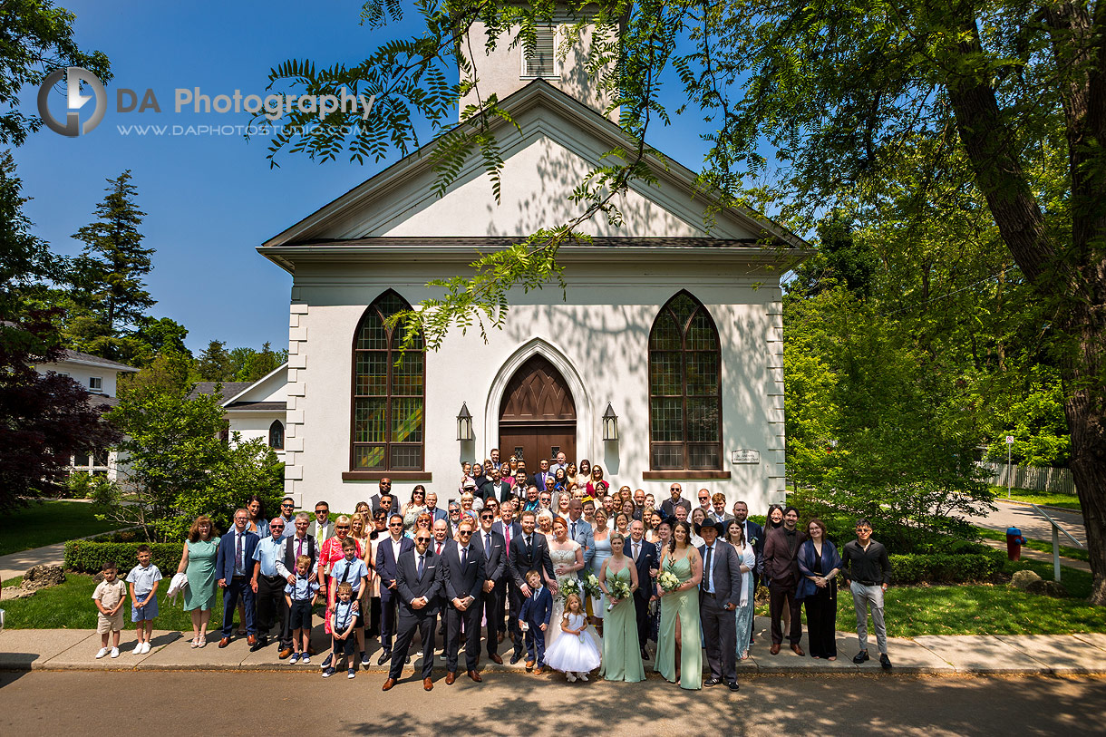 Large Group Photo of a bride and groom with their entire wedding guests at St. Andrew Church in Oakville