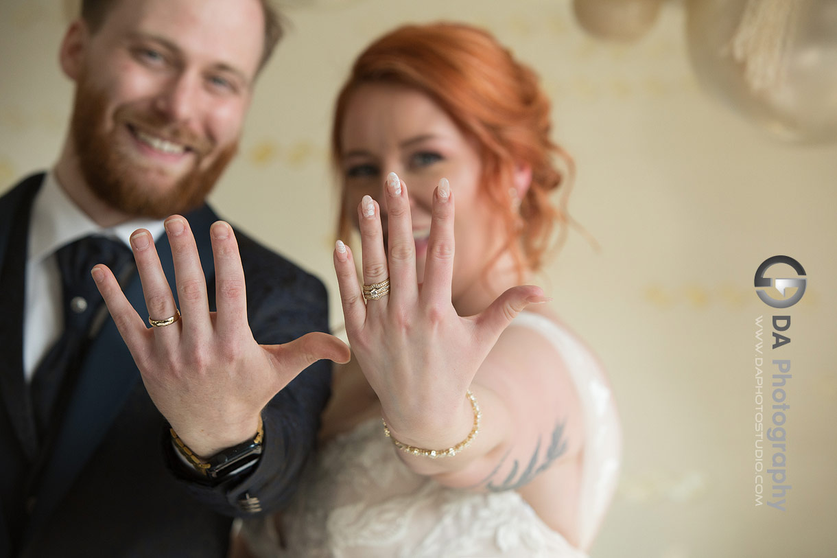 Photo of a Bride and groom showing their wedding rings